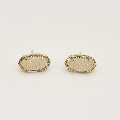 Kendra Scott oval gemstone stud earrings with sparkly beige crystal in gold bezel setting