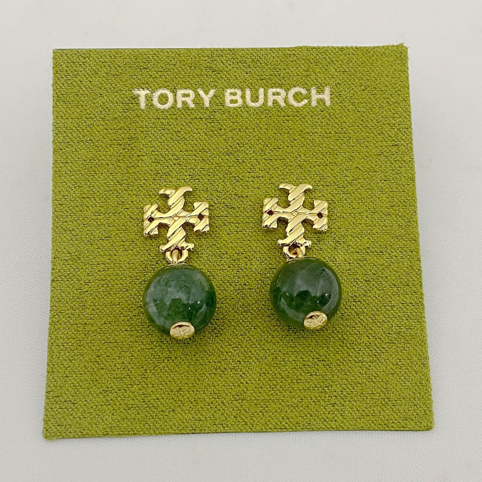 Gold-tone agate pendant earrings with round green stones and leaf-like motif