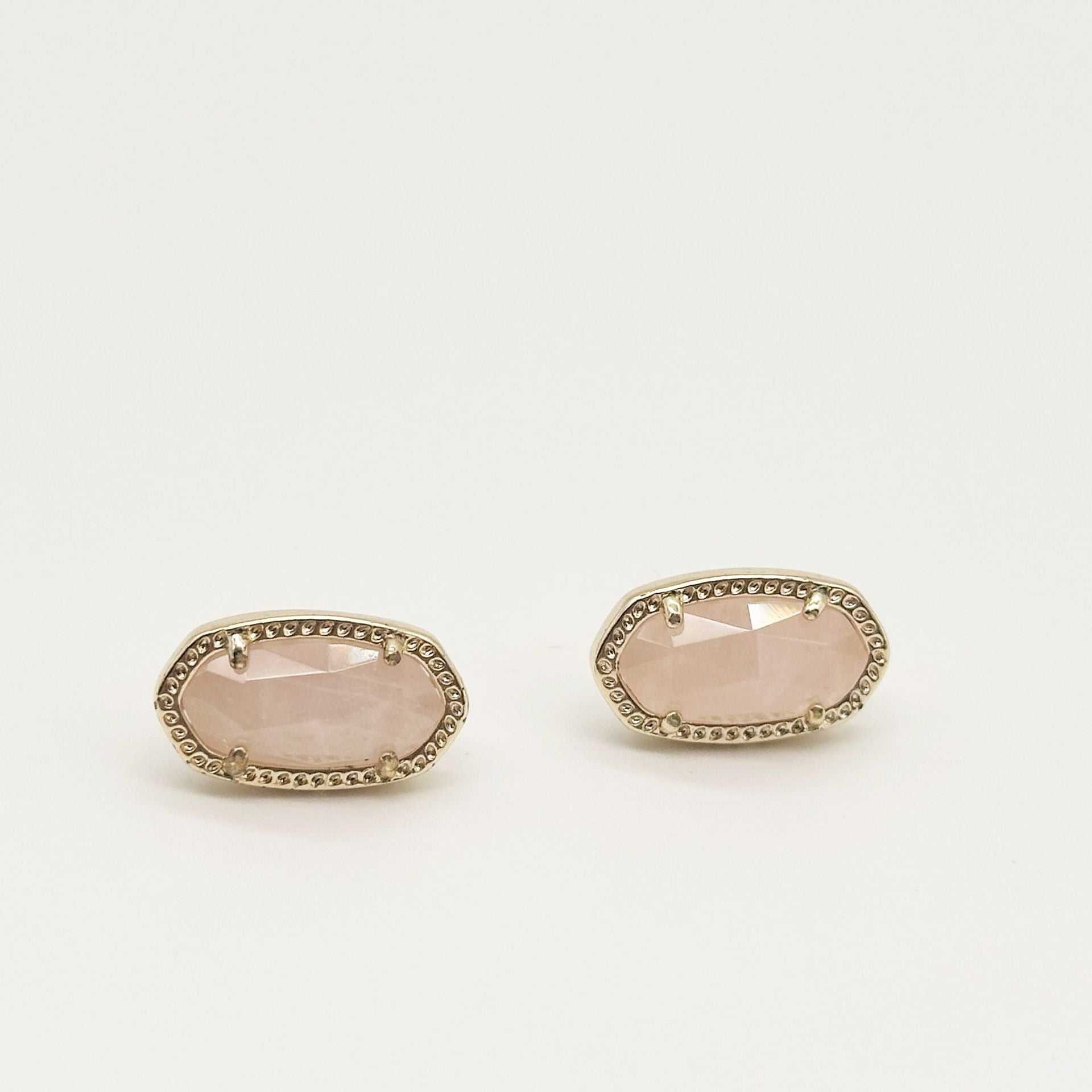 Kendra Scott oval gemstone stud earrings with light pink crystal in gold bezel setting