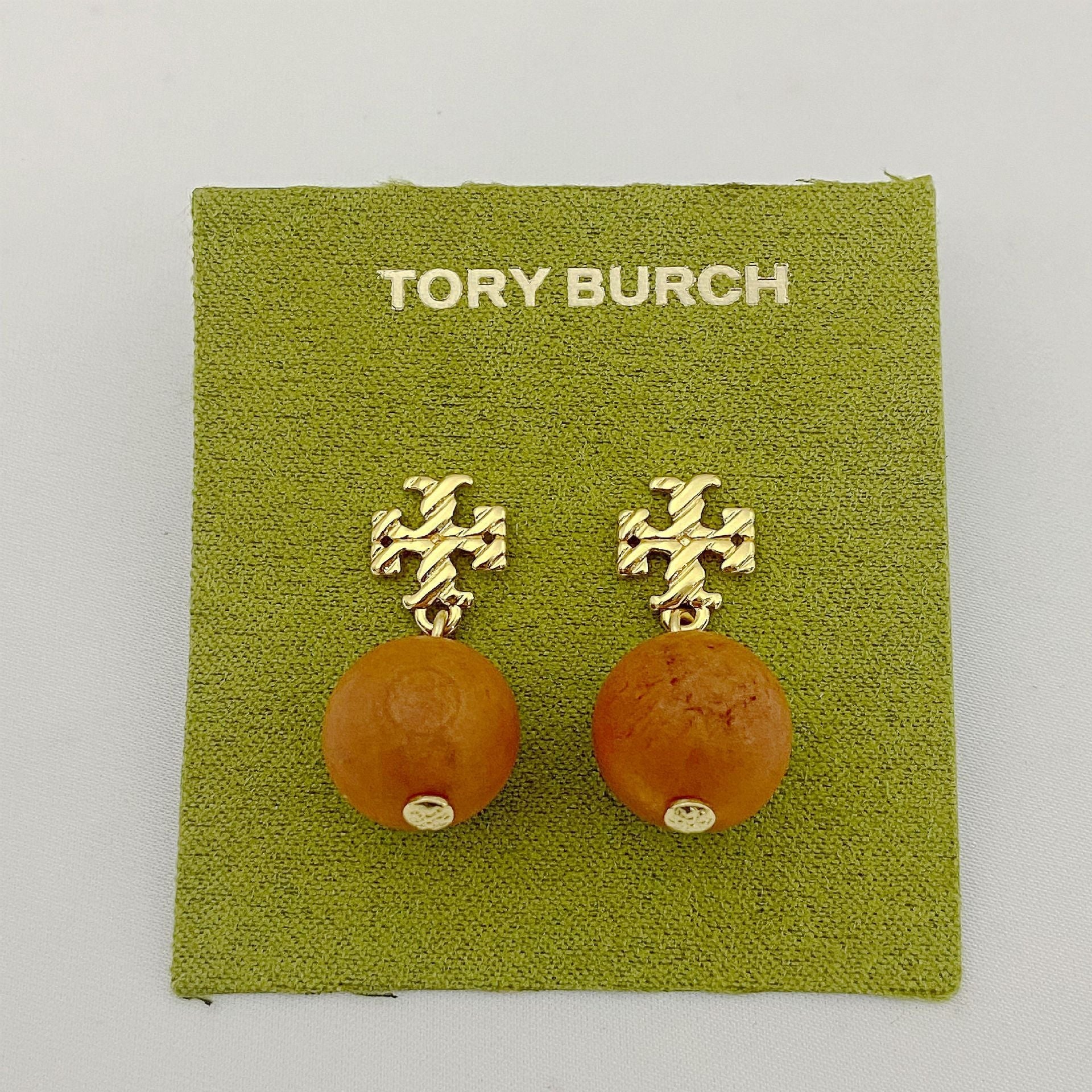 Tory Burch logo beaded pendant earrings, amber round beads, gold tone logo studs