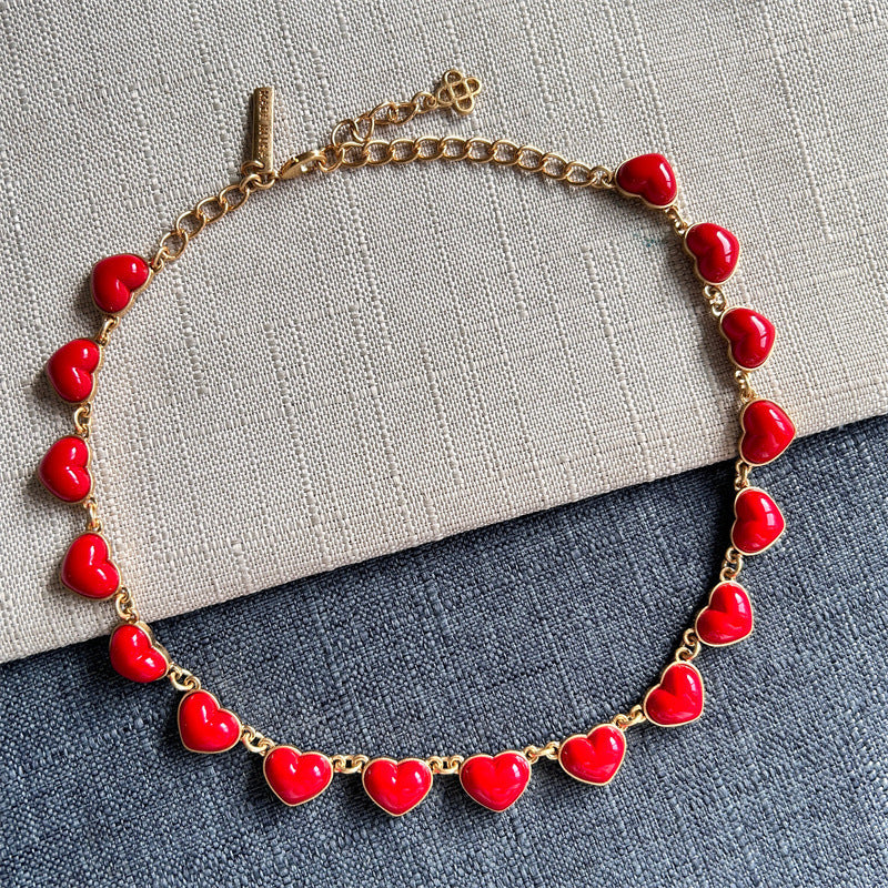 Red heart-shaped necklace with gold chain and glossy 3D heart pendants