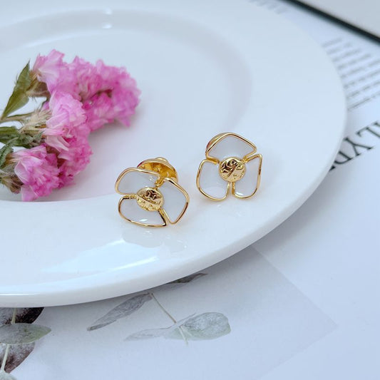 Tory Burch enamel camellia stud earrings with white petals and gold-tone frames