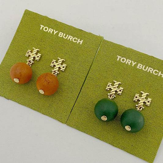 Tory Burch logo beaded pendant earrings, green and amber round beads, gold tone