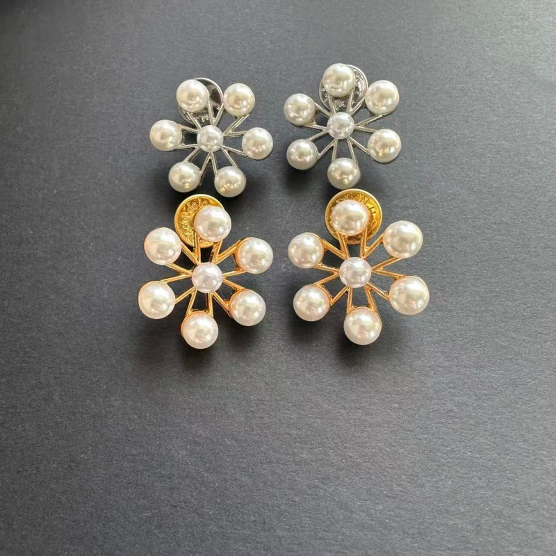 Pair of pearl flower earrings with gold-tone and silver-tone starburst frames