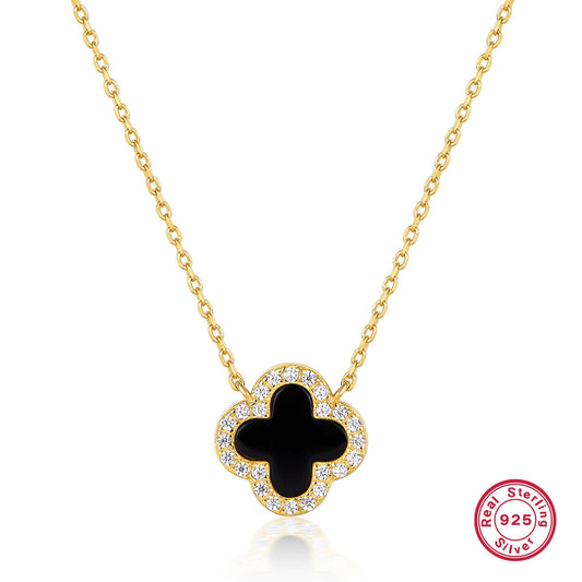 Gold-tone four-leaf clover necklace with black onyx center and clear stone border