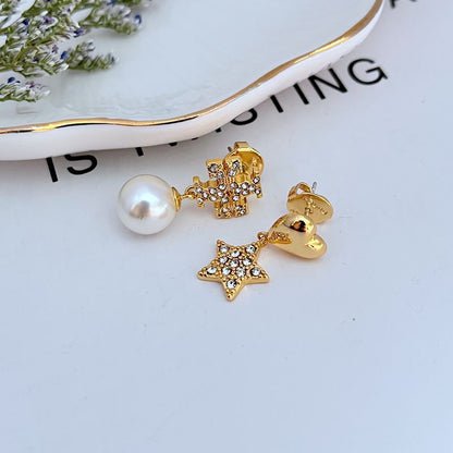 Gold-tone asymmetric earrings: heart charm, star charm, clear rhinestones, white pearl