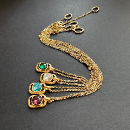Layered square pendant necklaces with hammered gold-tone frames and faceted gemstones