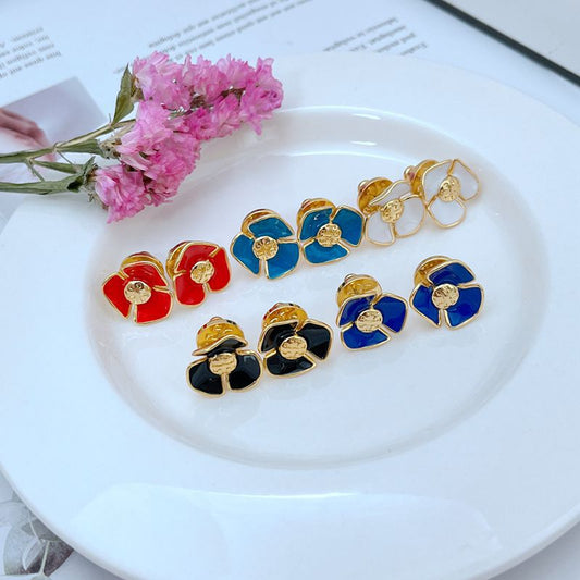 Tory Burch enamel camellia stud earrings assortment in red, blue, black, and white