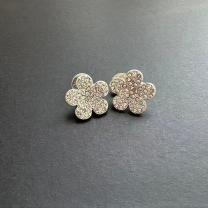 Silver-tone floral stud earrings with clear rhinestones