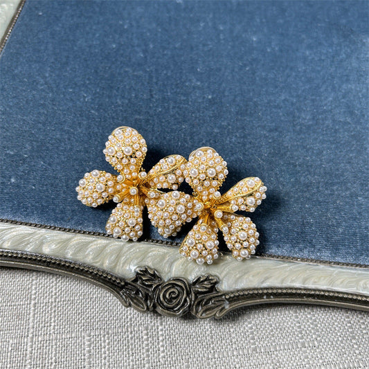 Five-petal flower stud earrings with white pearl-like beads and crystals on gold-tone setting