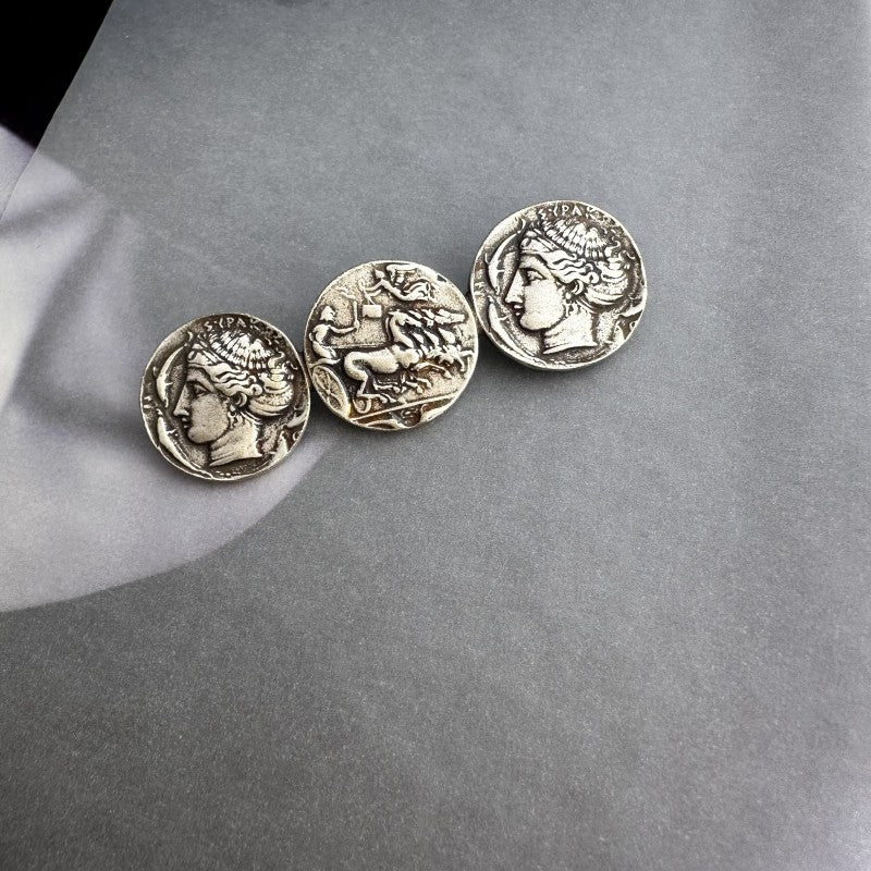 Silver-tone coin brooch with three round profile coins in aged finish