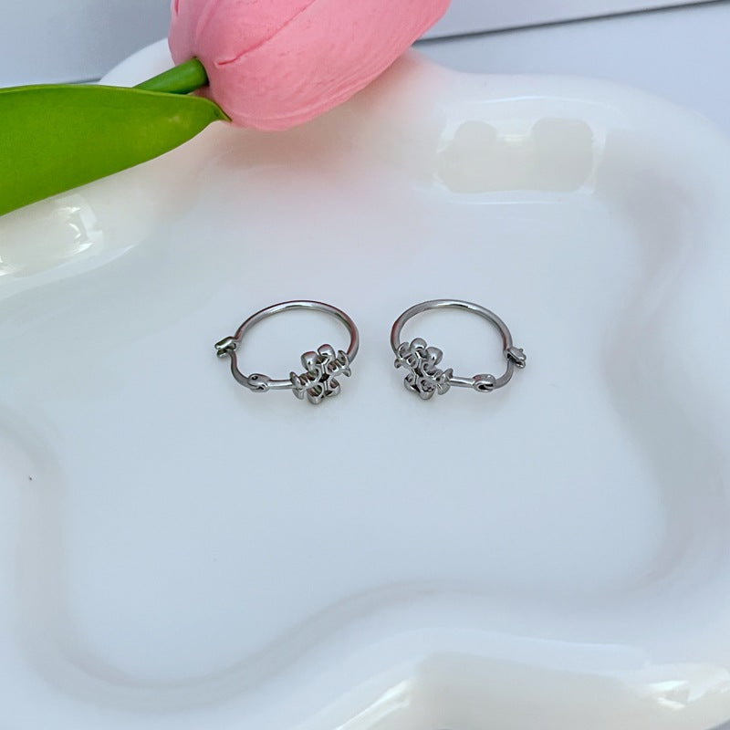 Silver-tone mini hoop earrings with small logo charm and hinged clasp