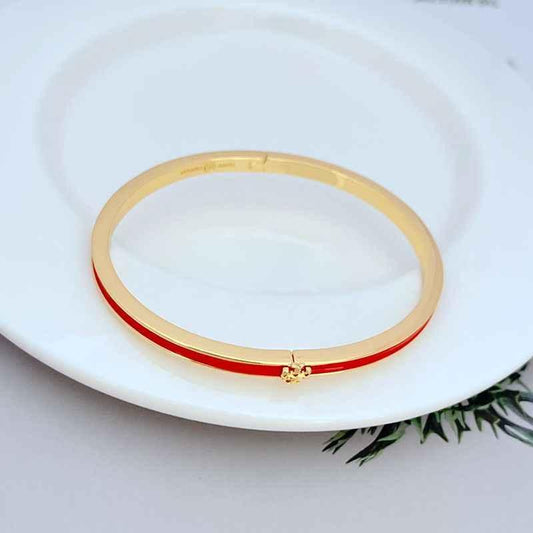 Enamel metal bracelet with gold-tone bangle and red bar detail