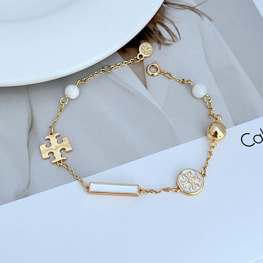 Gold-tone logo charm bracelet with white round beads and enamel logo circle accents