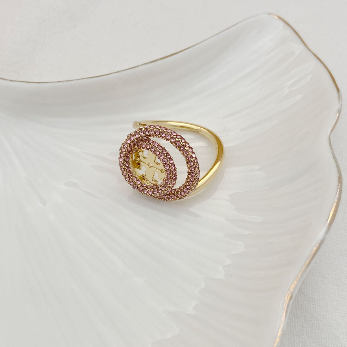 Gold-tone double hoop ring with pink pavé stones and open oval design