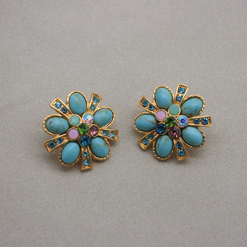 Gold-tone turquoise flower stud earrings with rainbow gemstone center and halo stones