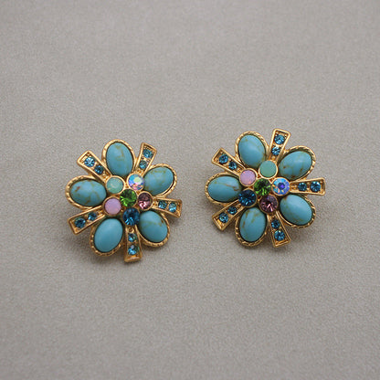 Gold-tone turquoise flower stud earrings with rainbow gemstone center and halo stones