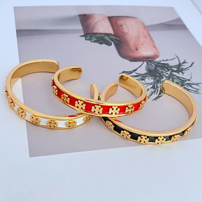 Enamel logo open metal bangles, red and black enamel with gold-tone logo detailing