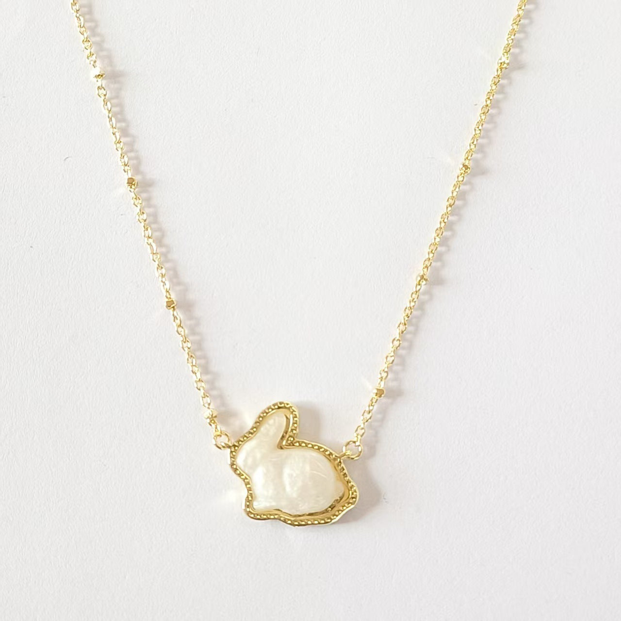 Gold-plated rabbit pendant necklace with white enamel on a gold chain