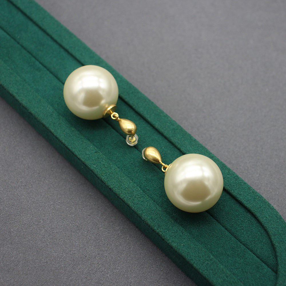 Gold faux-pearl drop earrings with large ivory spheres and chain-like gold links
