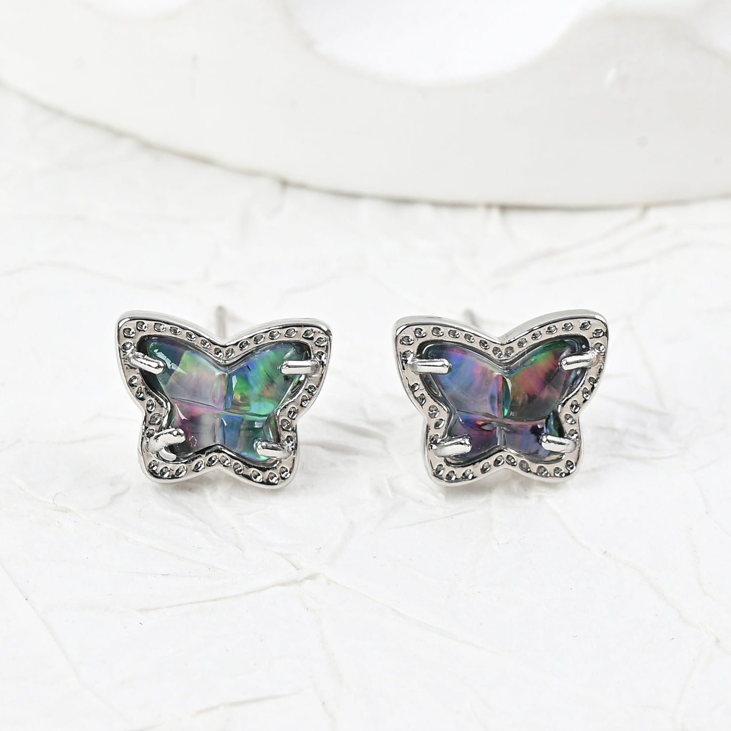 Silver butterfly stud earrings with iridescent multi-color stones