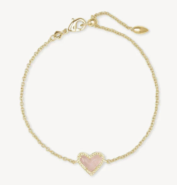 Adjustable heart charm bracelet with gold-tone chain and pink crystal heart pendant.