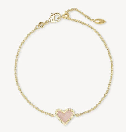 Adjustable heart charm bracelet with gold-tone chain and pink crystal heart pendant.