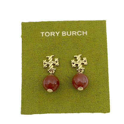 Gold-tone agate pendant earrings with round red stones and leaf-like top motif