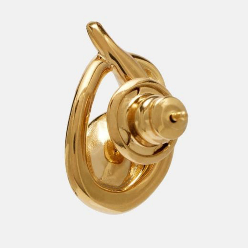 Gold-tone teardrop loop earring viewed from the side with a center stone