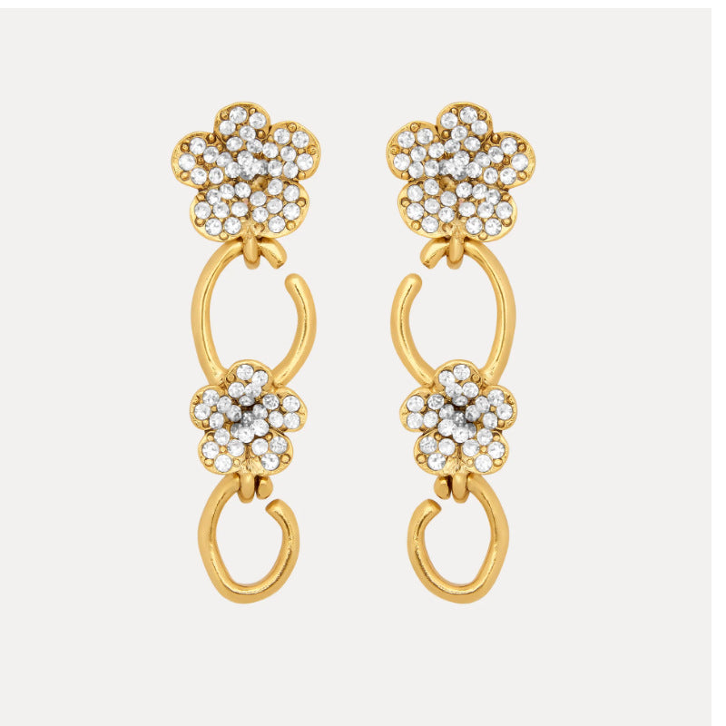 Floral dangle hoop earrings in gold tone with clear crystal flower clusters and loops