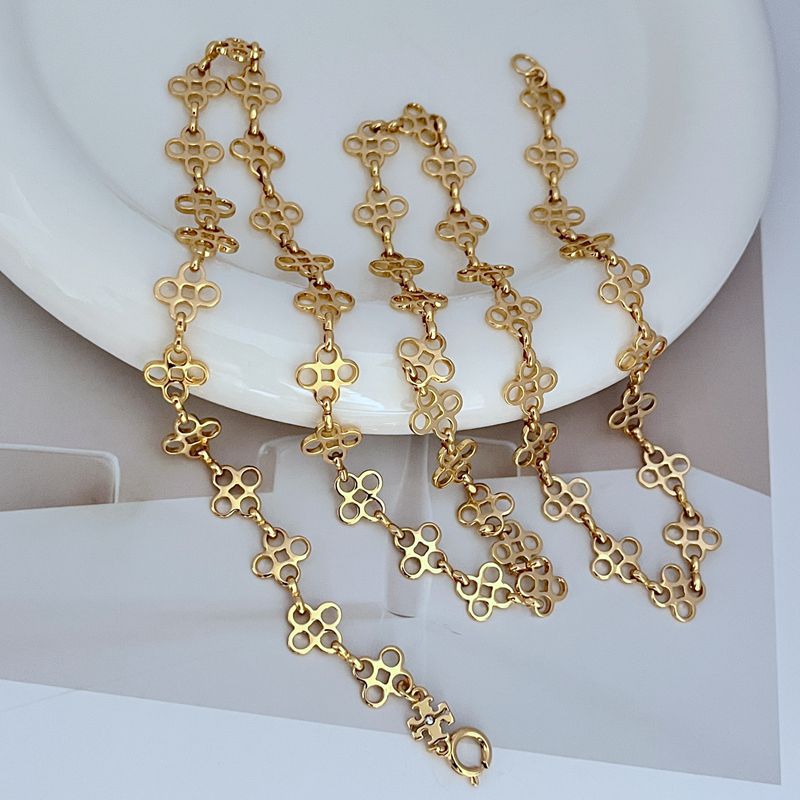 Four-leaf clover sweater chain necklace with gold-tone linked pendant drops