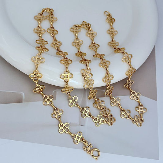 Four-leaf clover sweater chain necklace with gold-tone linked pendant drops