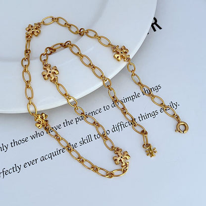 Gold-tone chain bracelet and necklace set with clover logo link charms