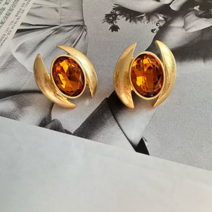 Gold-tone oval crystal stud earrings with amber faceted stones