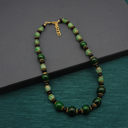 Vintage green glass bead necklace with gold-tone links and clasp