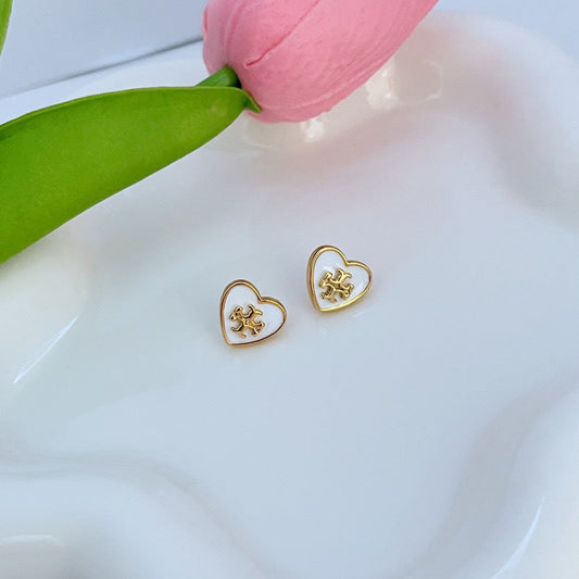 Enamel heart stud earrings with gold-tone frames and white heart face