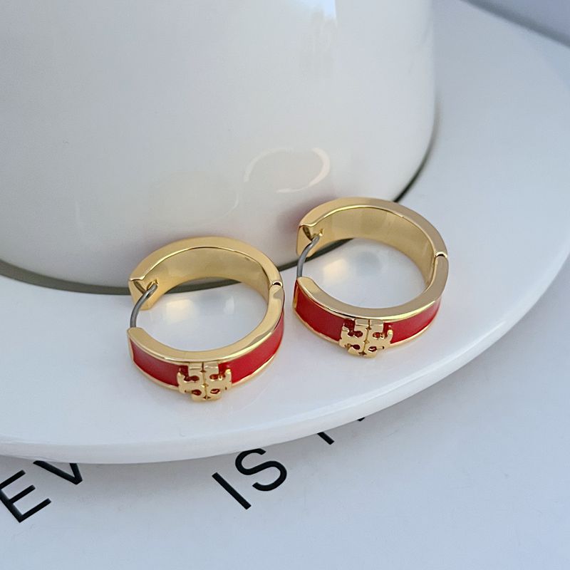 Gold-tone round hoop earrings with red enamel band and decorative front detail