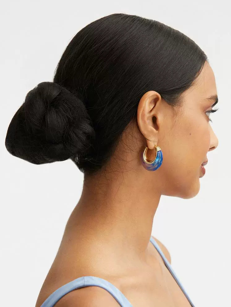 Ombré U-shaped hoop earrings on model, gold-tone edges with blue to purple resin gradient