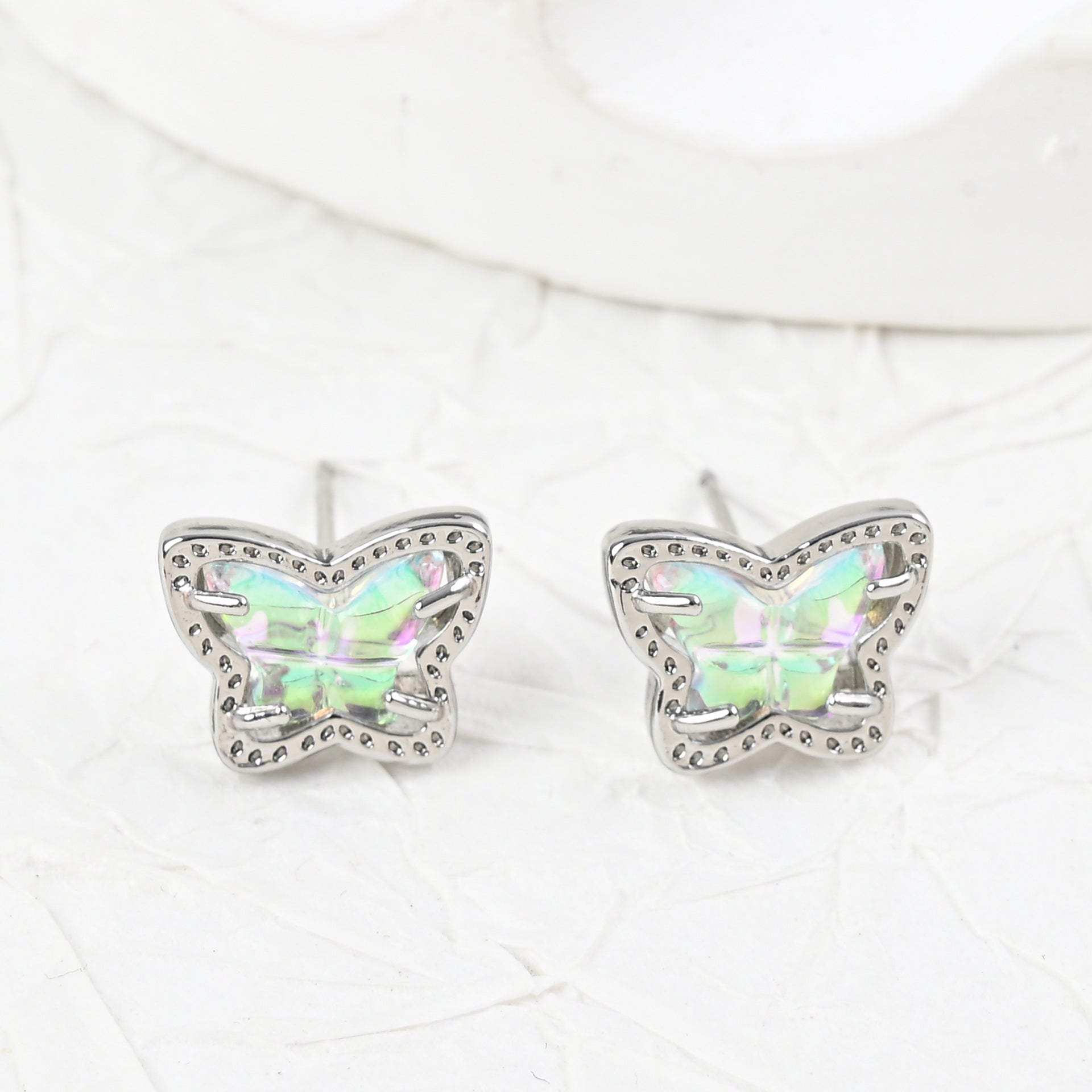 Silver butterfly stud earrings with iridescent multi-color stones, pair