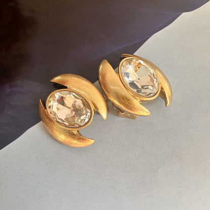 Gold-tone oval crystal stud earrings with clear faceted stones