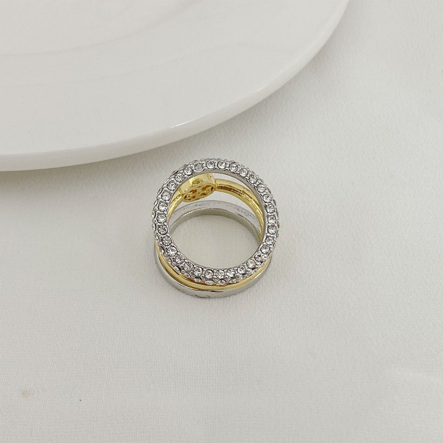 Rhinestone outer band three-band ring with gold center and open silver frame