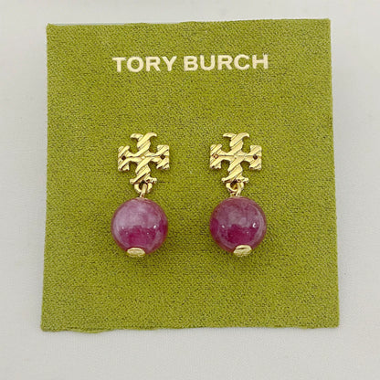 Gold-tone agate pendant earrings with round magenta stones and leaf-like top motif
