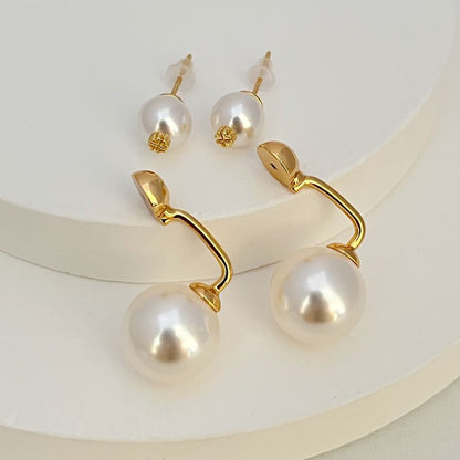 Gold-tone pearl earrings with large drop pearls and small stud pearls