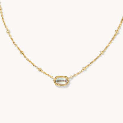 Gold-tone necklace with small oval white gemstone pendant on a fine chain.
