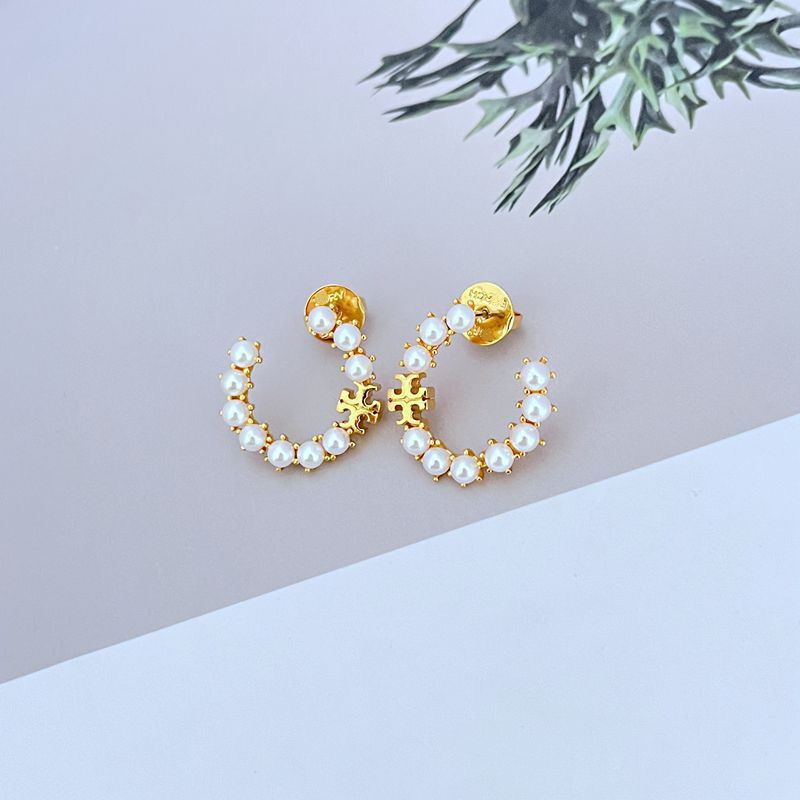 Gold C-shaped hoop earrings with white pearl beads and raised logo detail