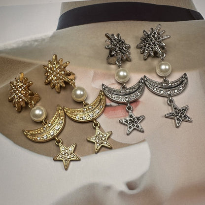 Star and moon drop earrings in mixed gold and silver tones with pearl accents