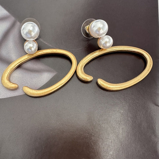 Gold-tone O-ring hoop earrings with two white pearls on each stud
