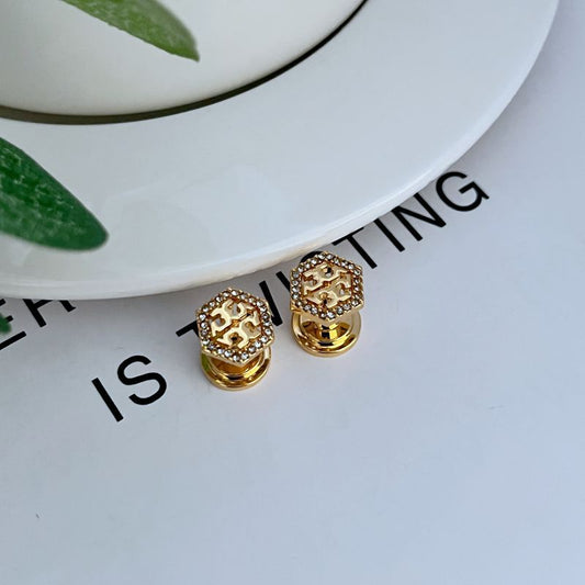 Gold hexagonal openwork metal stud earrings with pavé gems