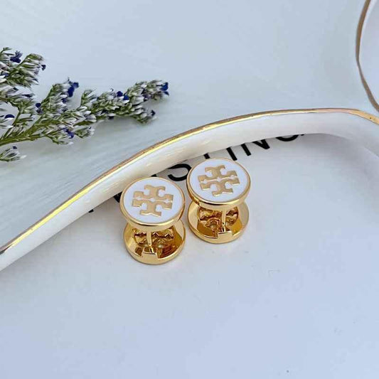 Reversible enamel rhinestone stud earrings, round white front and gold-tone back, close-up pair