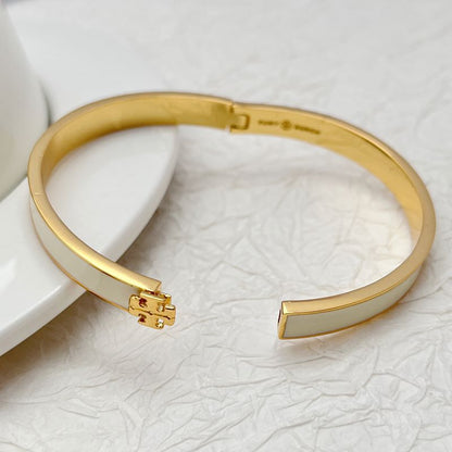 Tory Burch enamel metal bangle, gold-tone with hinge clasp and inner engraving